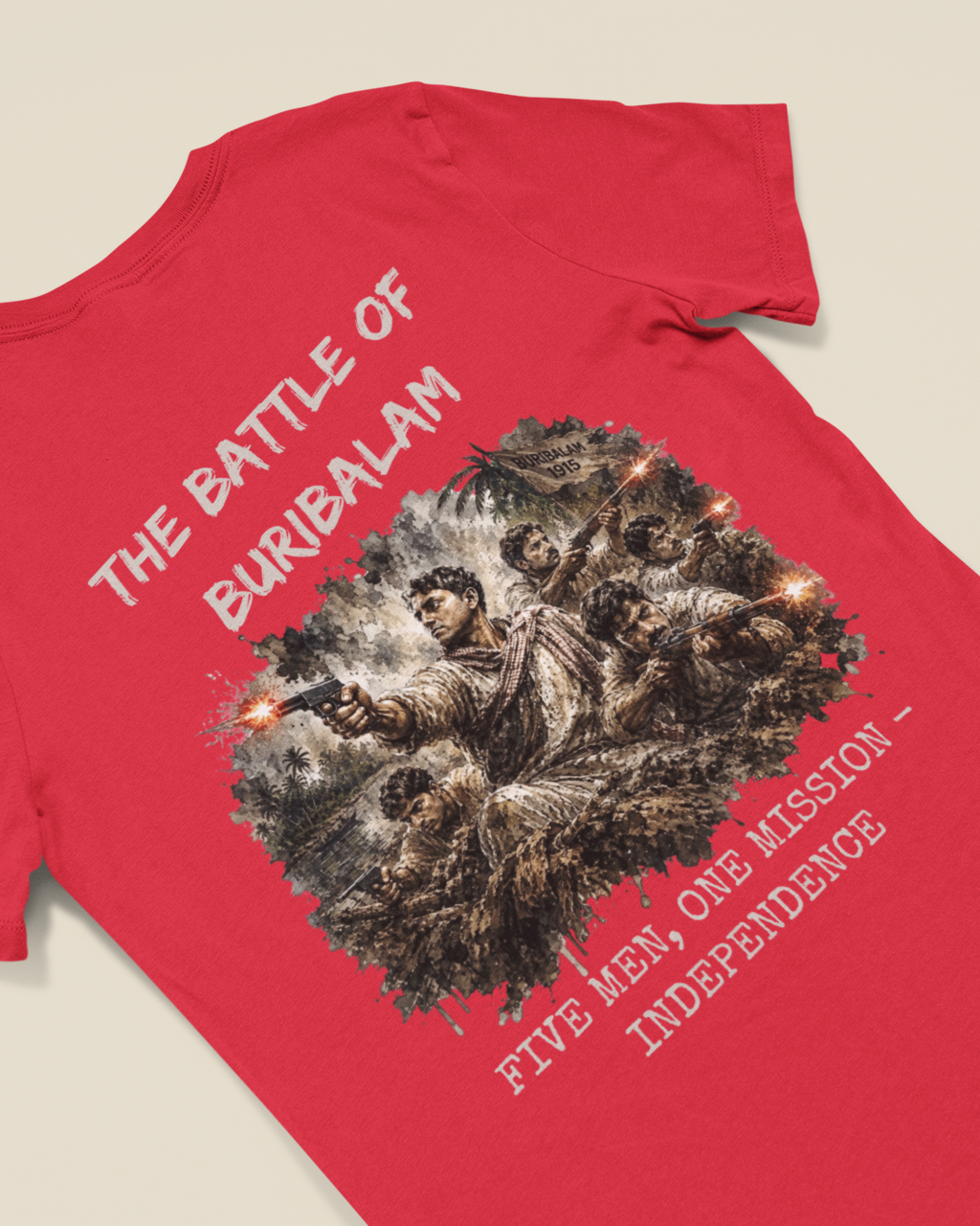 A red short-sleeve t-shirt laid flat on a light beige background, featuring a large graphic print of soldiers in combat with the text 'THE BATTLE OF BURBALAM' and 'FIVE MEN, ONE MISSION - INDEPENDENCE'.