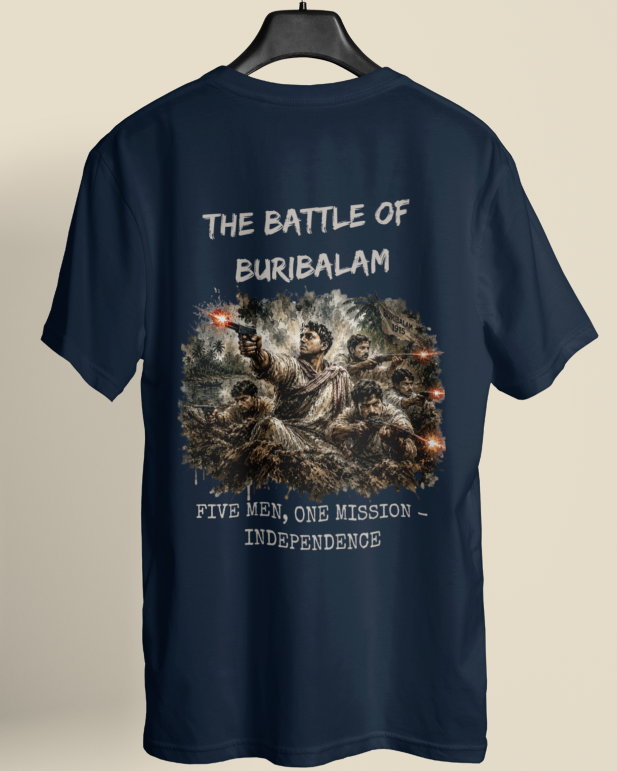 A navy blue short-sleeve t-shirt hanging on a black hanger against a light beige background. The back of the shirt features a large graphic print depicting a historical battle scene with soldiers and the text 'THE BATTLE OF BURIBALAM' and 'FIVE MEN, ONE MISSION - INDEPENDENCE' in white distressed lettering.