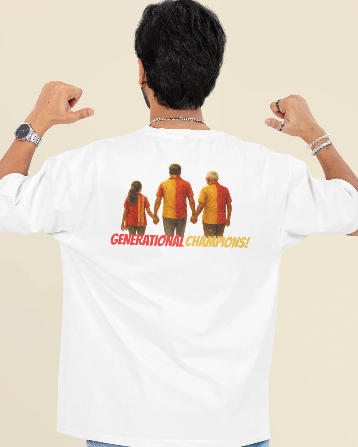 A man shown from behind wearing a white t-shirt with a graphic print on the back. The graphic features three figures in red and yellow shirts holding hands, with the text 'GENERATIONAL CHAMPIONS!' in red and yellow.
